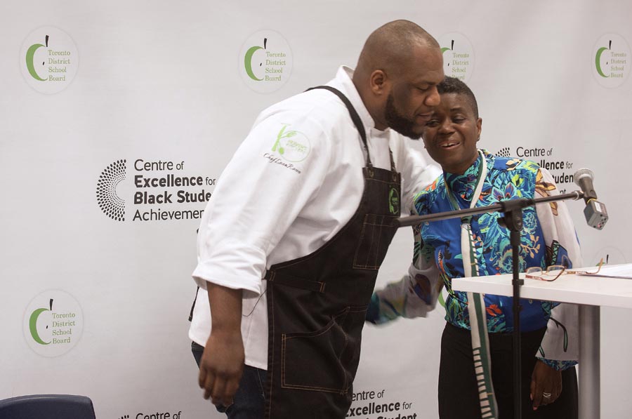 Chef Leon Rowe and System Superintendent Karen Murray greet each other.  Open Gallery